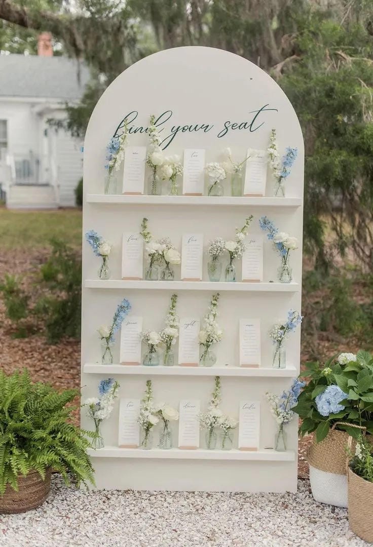 wedding welcome table with framed sign and floral arrangement