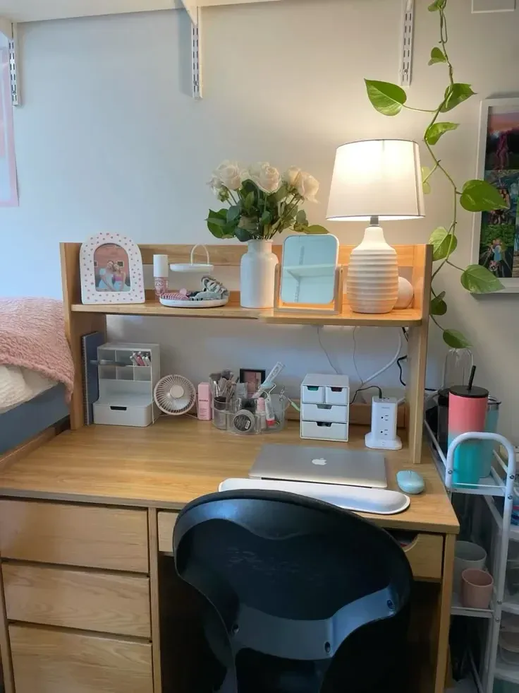 dorm desk ideas with a small shelf lamp flowers and storage cubes above a desk