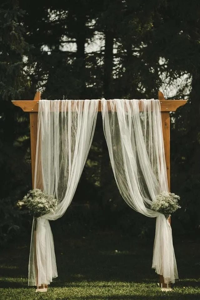 wedding aisle decor with greenery garland and flowers