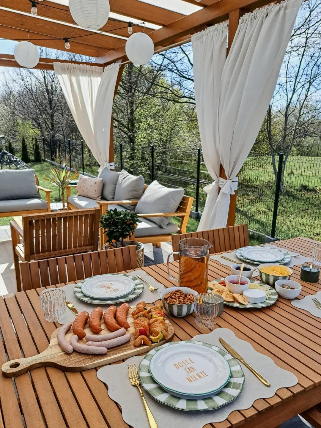 backyard party aesthetic ideas with serve snacks on a pergola table