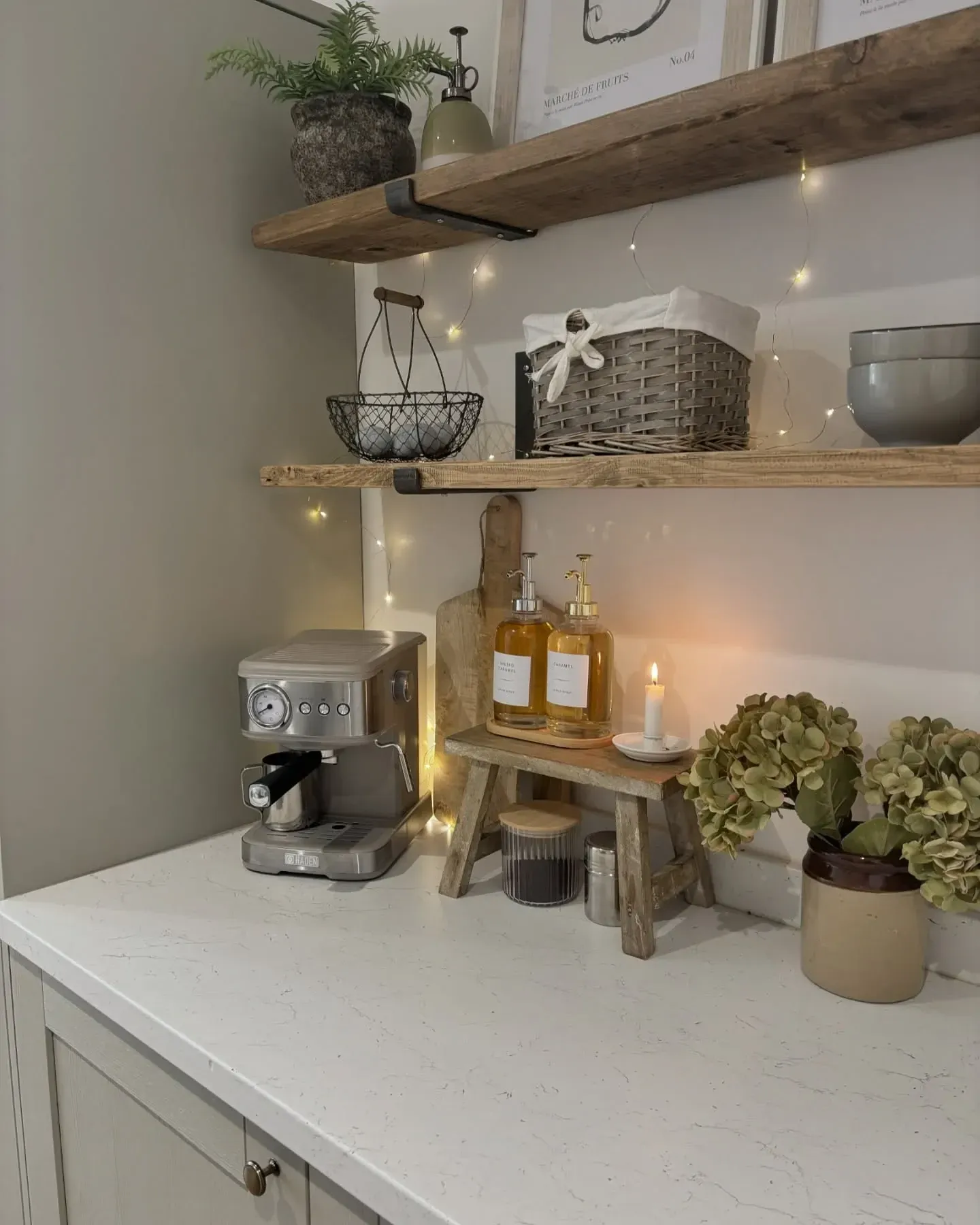 countertop coffee station ideas with neutral mugs, machine, plant, and small jars