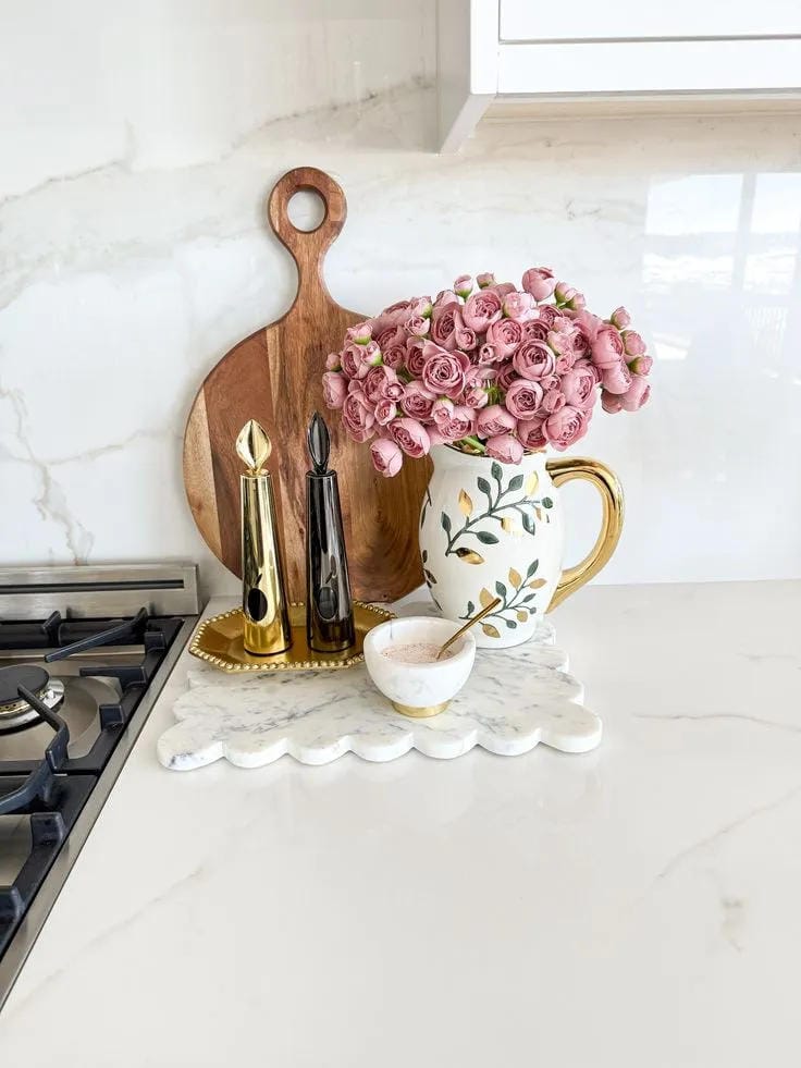 kitchen counter decor ideas with pink flowers pitcher oils and cutting board by stove