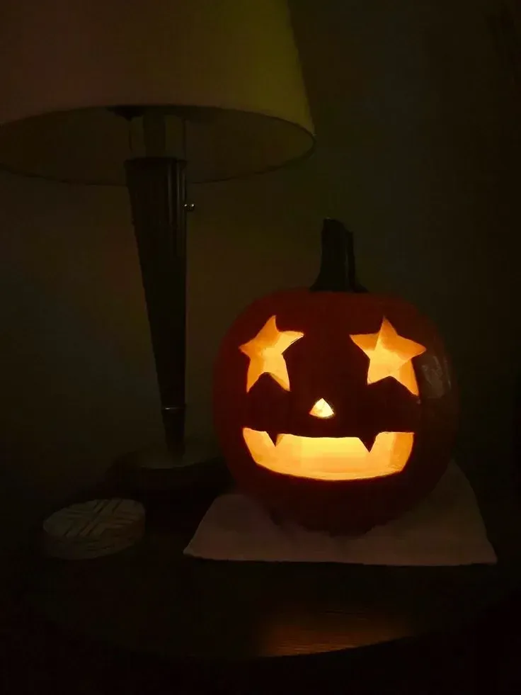 kid friendly pumpkin carving ideas with star eyes, glowing smile, and easy jack o lantern face