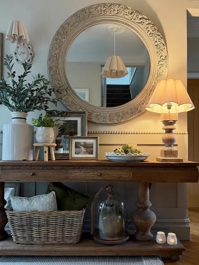 home entrance decor with ornate round mirror lamp plants and wood entry table