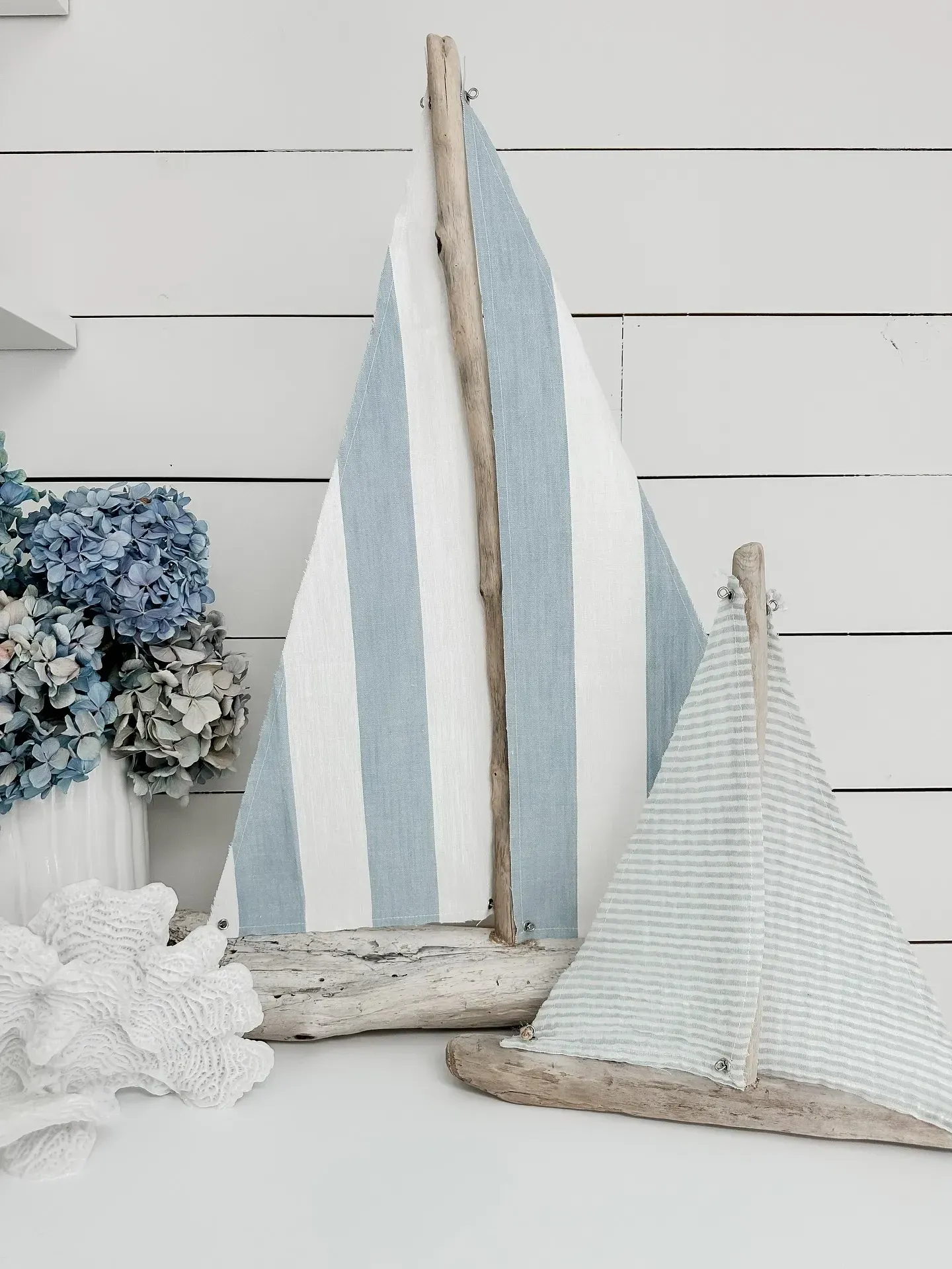classic coastal living room ideas with striped sailboat decor, blue hydrangeas, and white table