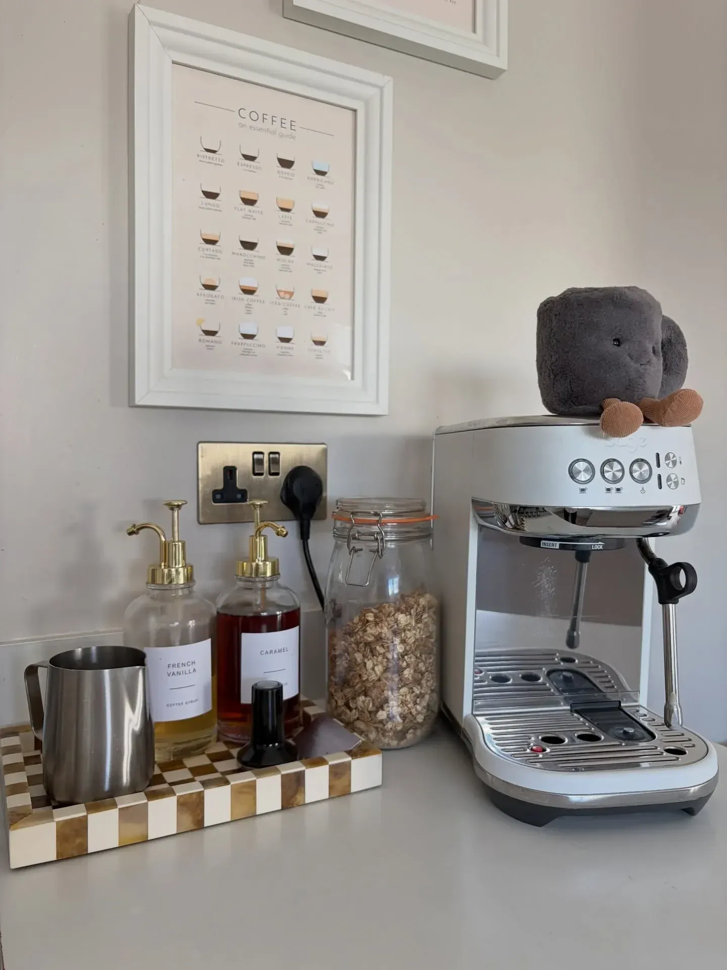 modern coffee station ideas with espresso machine, small shelf, syrups, and mugs