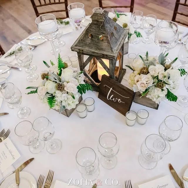 rustic wedding centerpiece with low flowers and taper candles