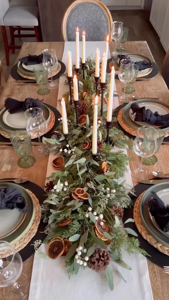 fall tablescape ideas with a greenery runner tall candles glassware and dark napkins