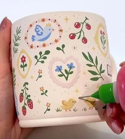 painted flower pot idea with tiny cottagecore flowers cherries birds and vines