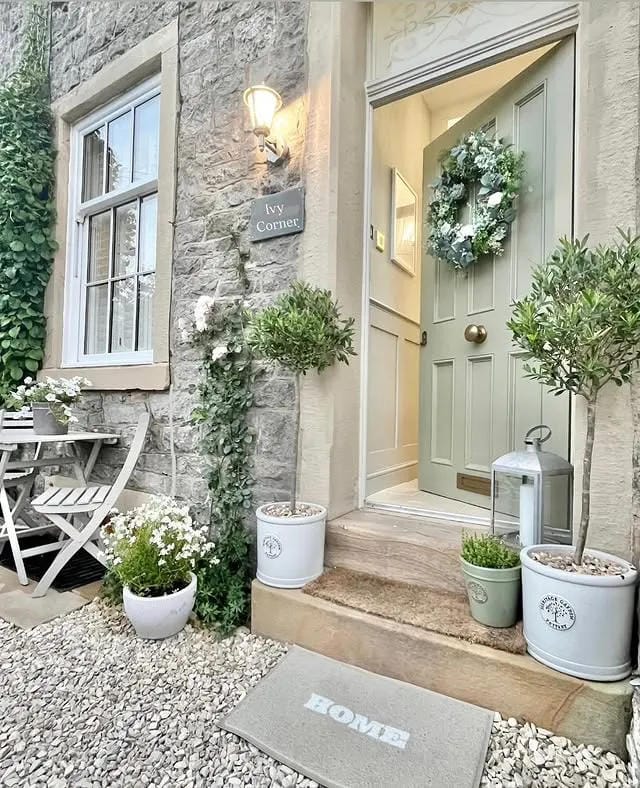 tiny porch decor with flowers and a cute doormat