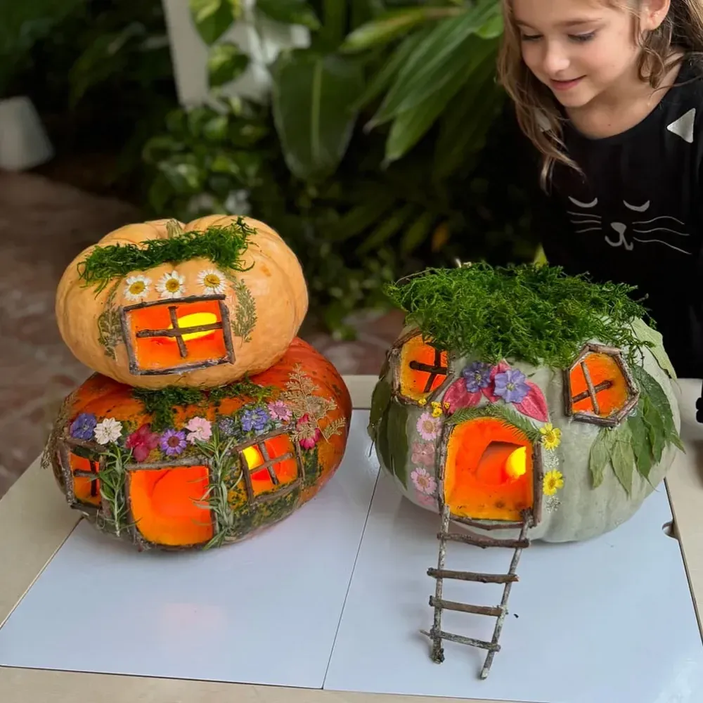 kid friendly pumpkin carving ideas with little pumpkin houses, cut out windows, tiny doors, moss, and mini ladders