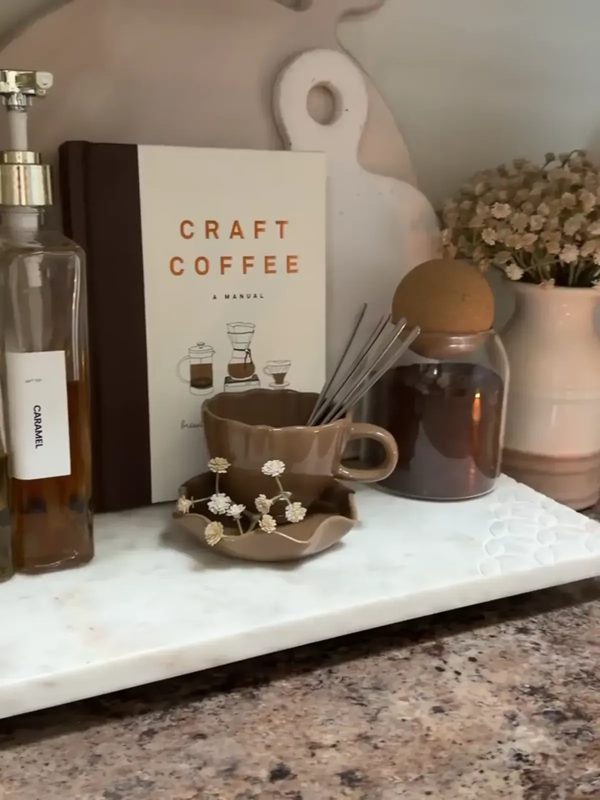coffee station ideas with espresso machine, syrups, mugs, and a small countertop tray