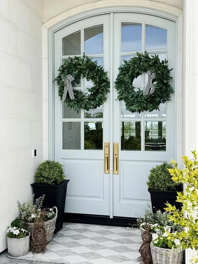 small front porch ideas with double door wreaths black planters and woven baskets