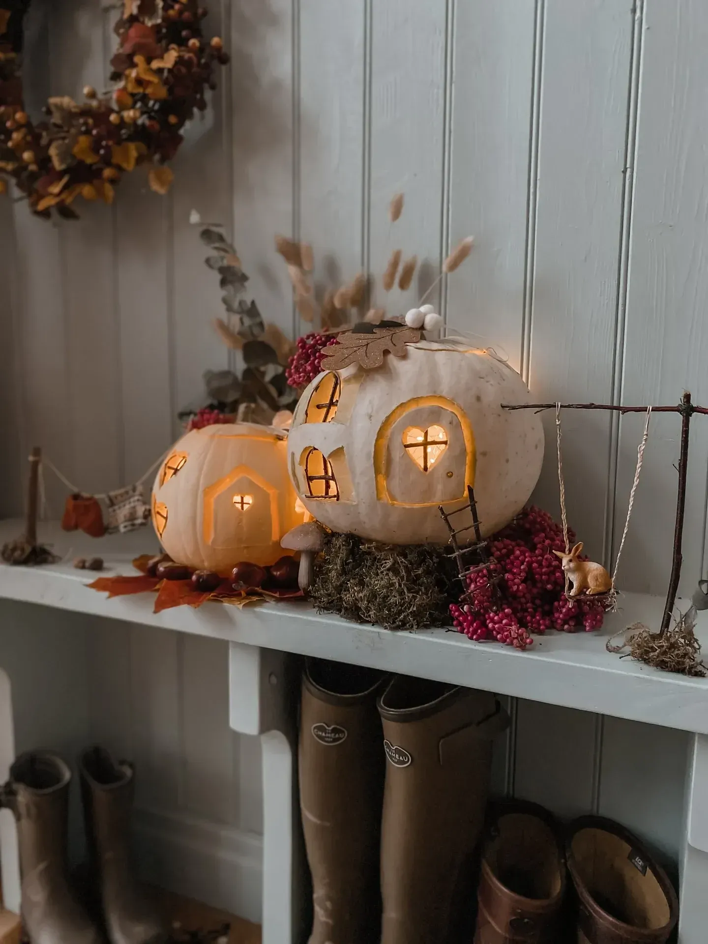 kid friendly pumpkin carving ideas with little pumpkin village, white pumpkin houses, glowing windows, tiny doors, and fall display
