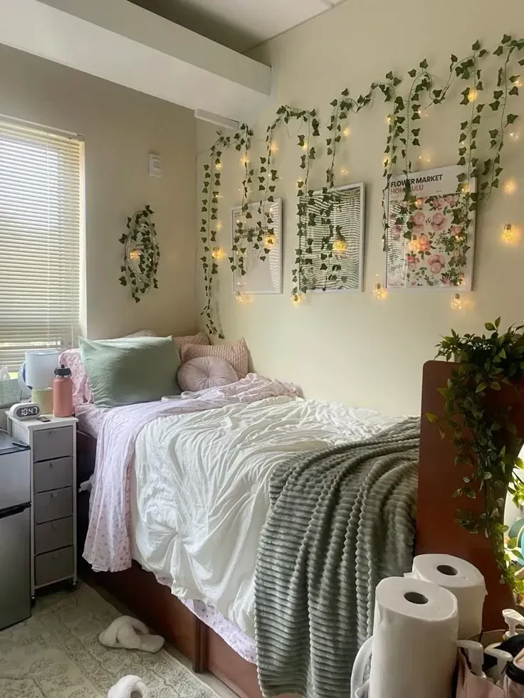 pink and green dorm room ideas with vine wall decor fairy lights and white bedding