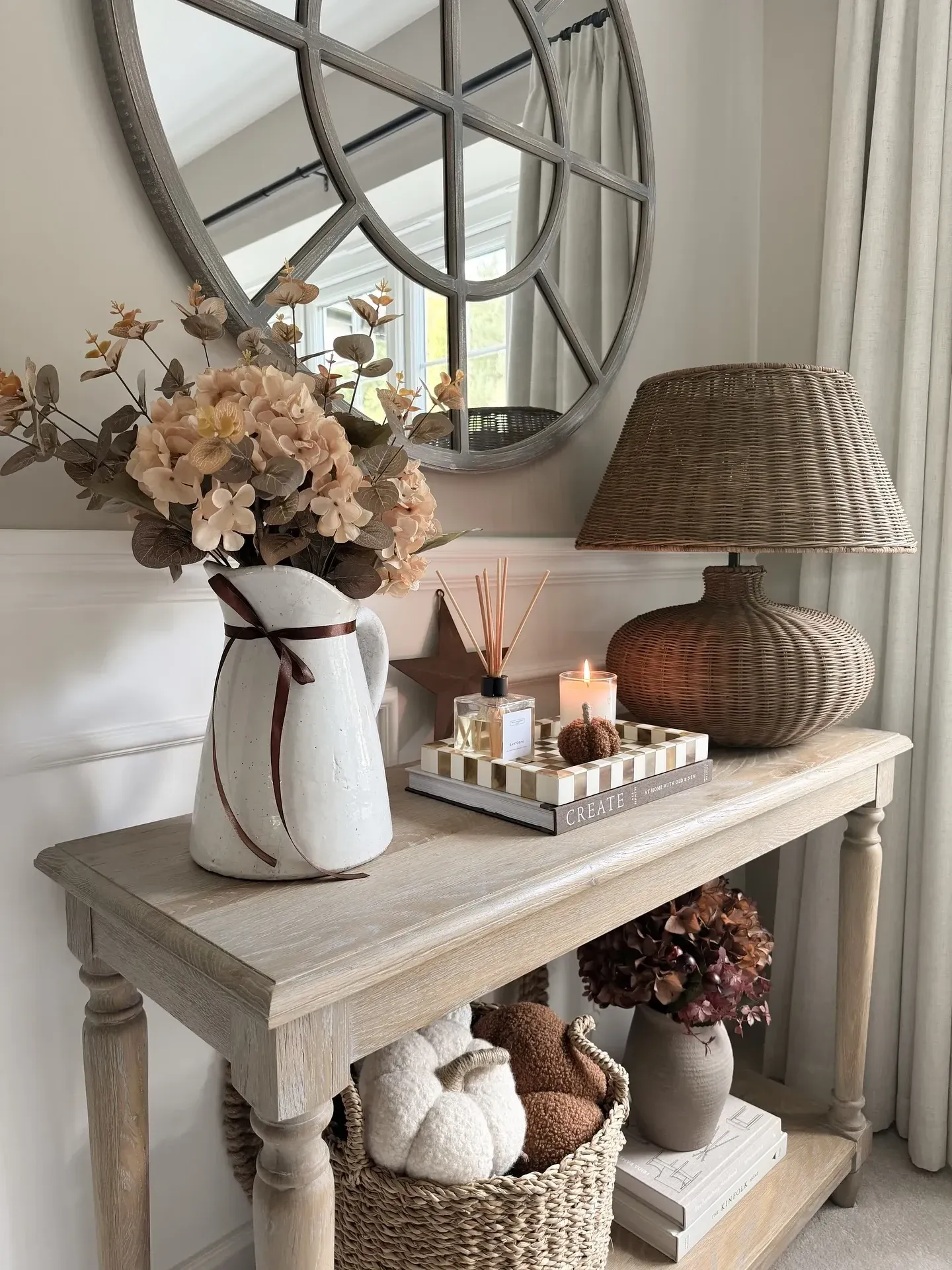 fall table decor ideas with white pitcher centerpiece, soft flowers, candles, pumpkins, and neutral autumn table styling