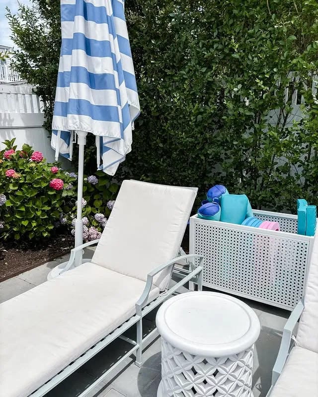 poolside storage idea with bins for towels and toys