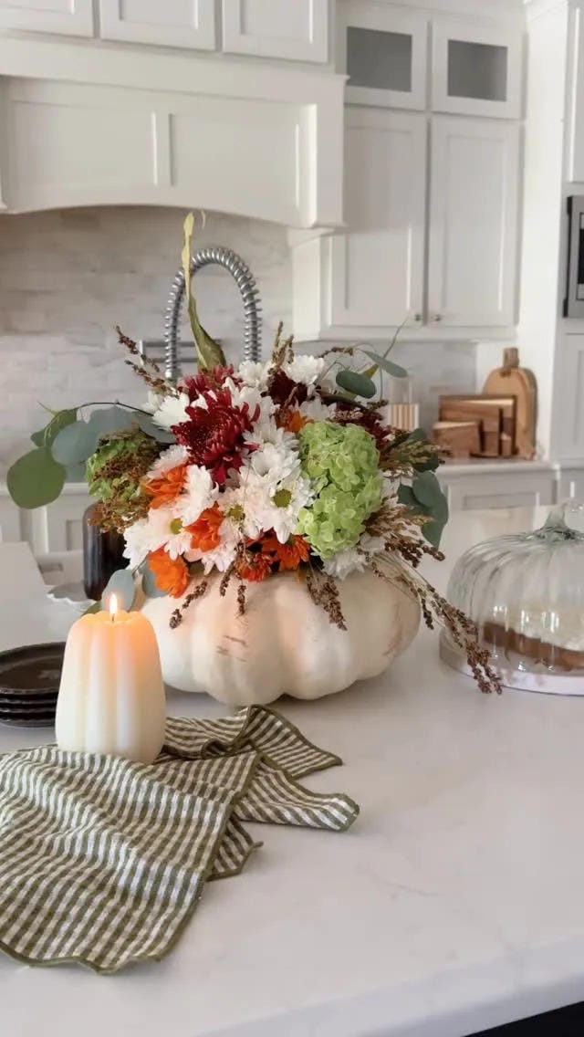 fall flower arrangement ideas with a white pumpkin vase and orange fall flowers