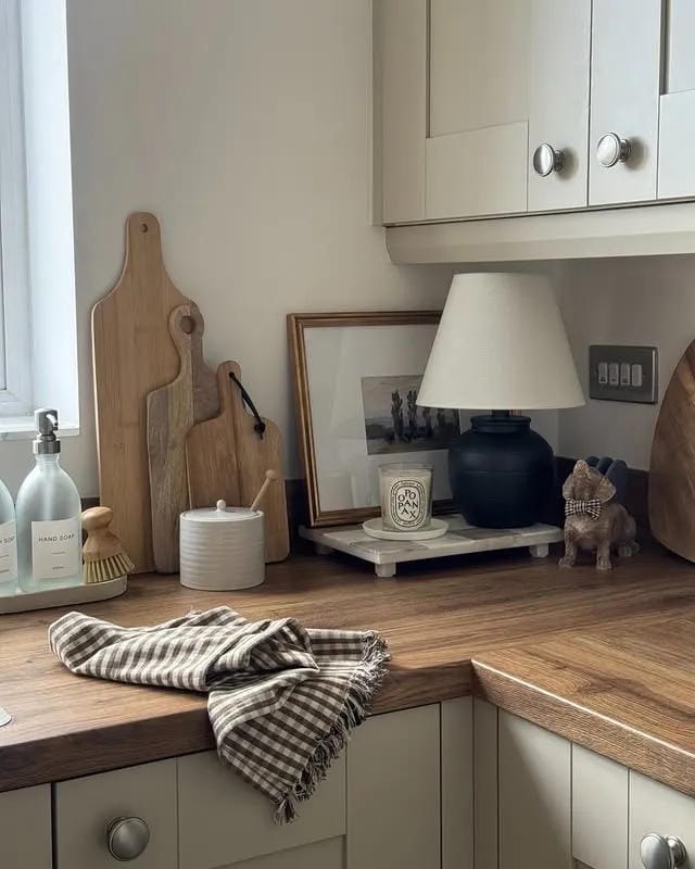 kitchen counter decor ideas with wood counter framed art cutting boards and candle
