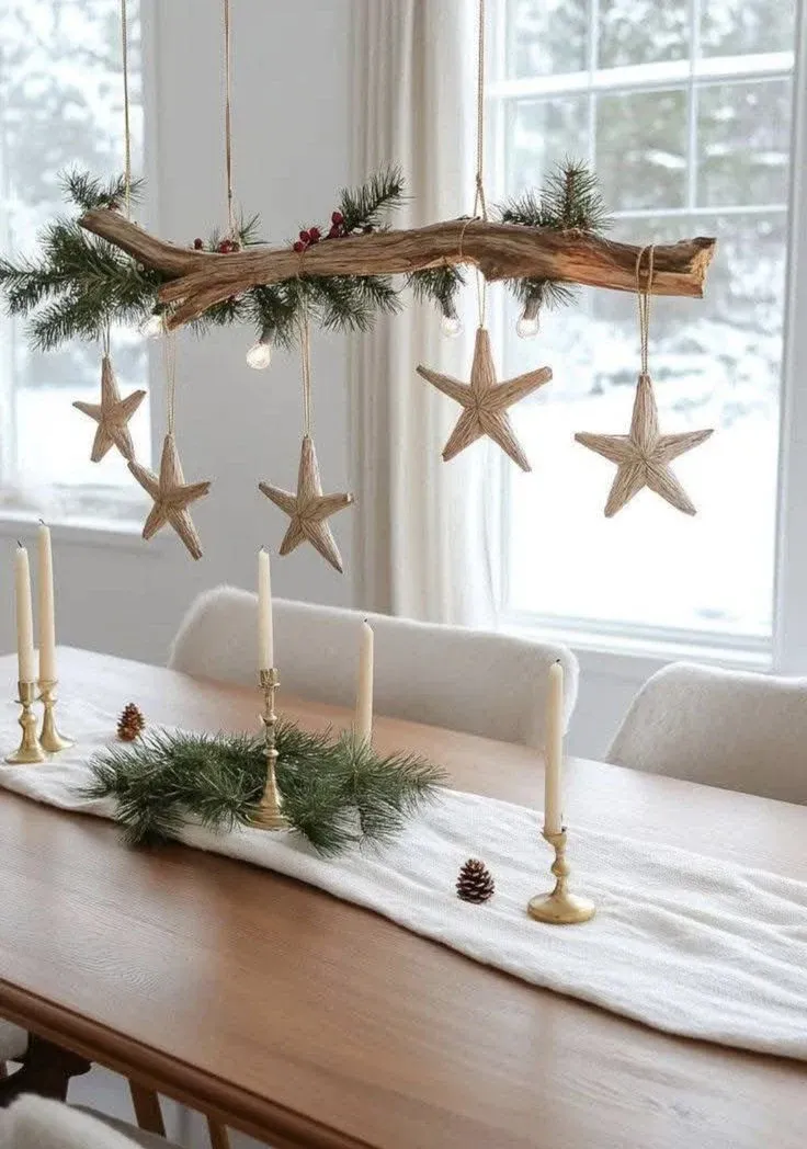 Hanging star branch above a dining table for Scandinavian Christmas decor