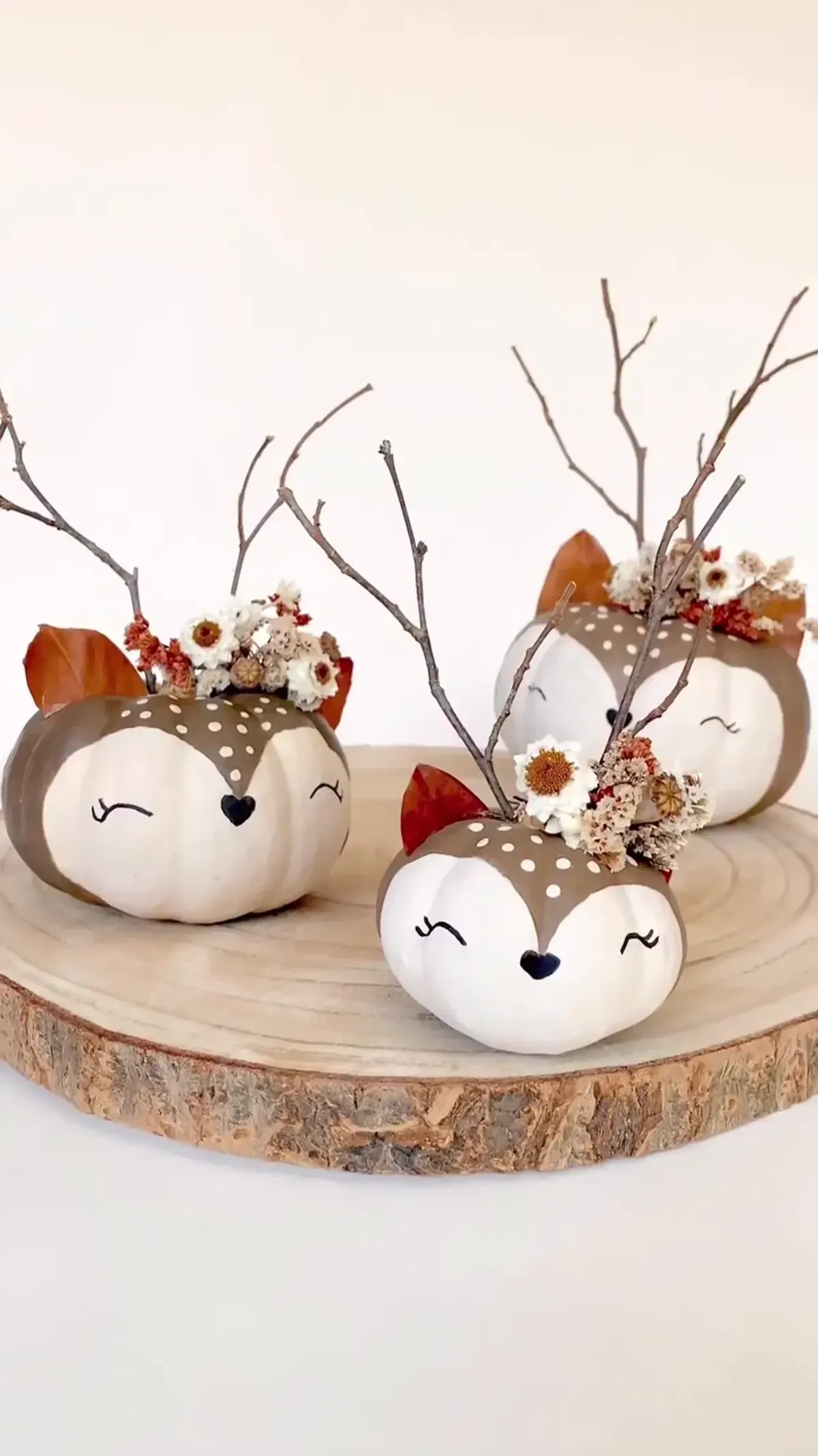 kid friendly pumpkin carving ideas with white woodland pumpkins, twig antlers, ears, and cute painted faces