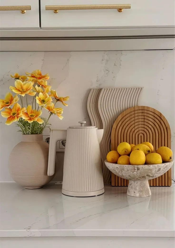 kitchen counter decor ideas with yellow flowers lemons pitcher and wood boards